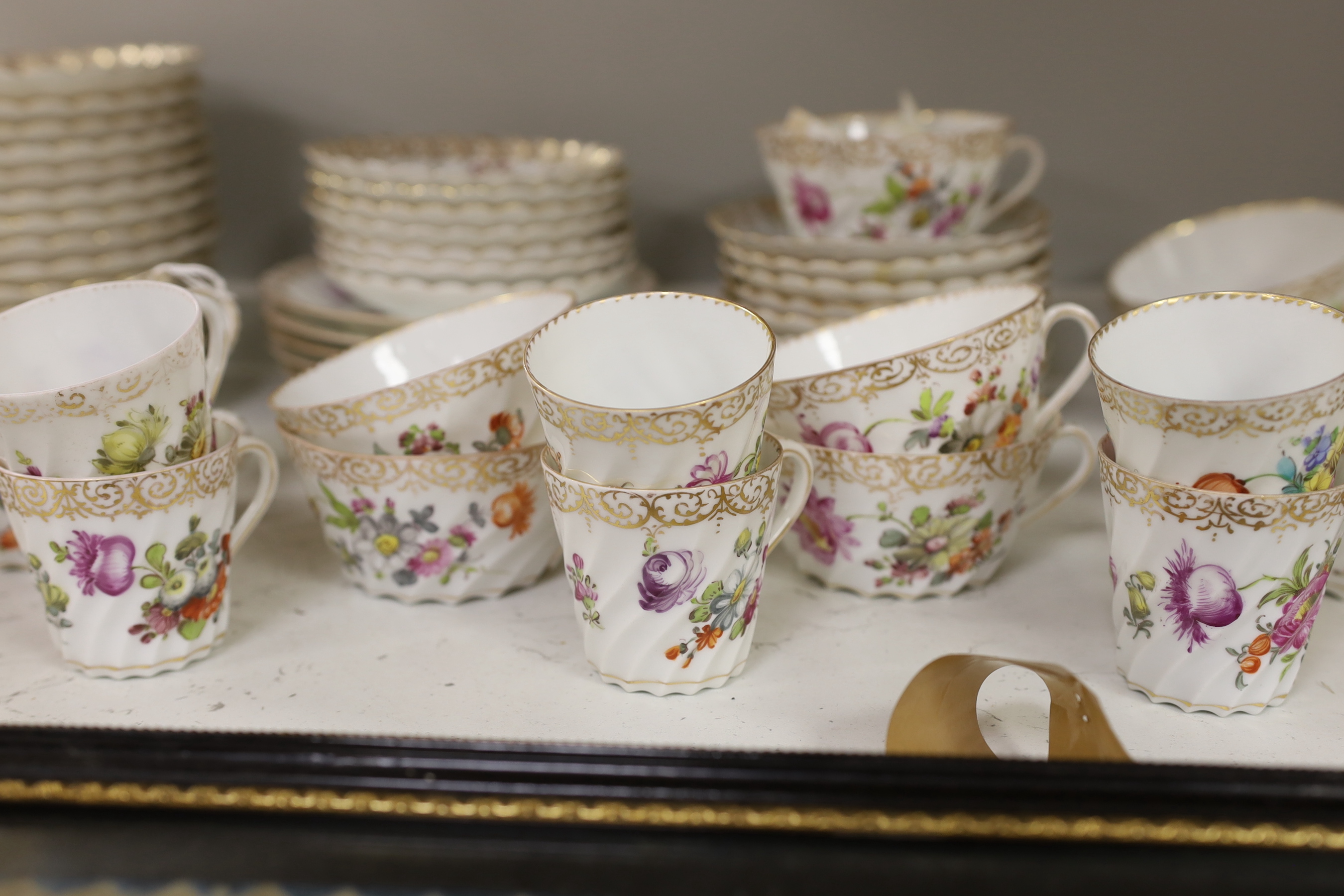 A quantity of Dresden flower painted tea wares